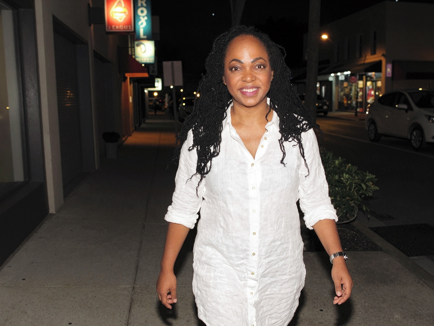 Kimberly M. Bonner walking confidently on a city street at night